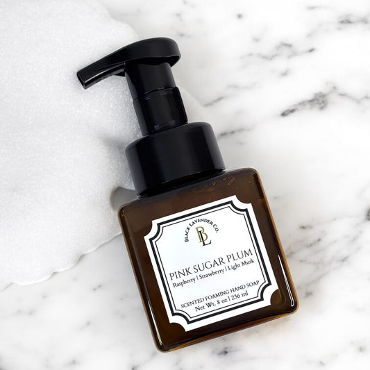 Hand soap bottle labeled 'Pink Sugar Plum' on a marble surface