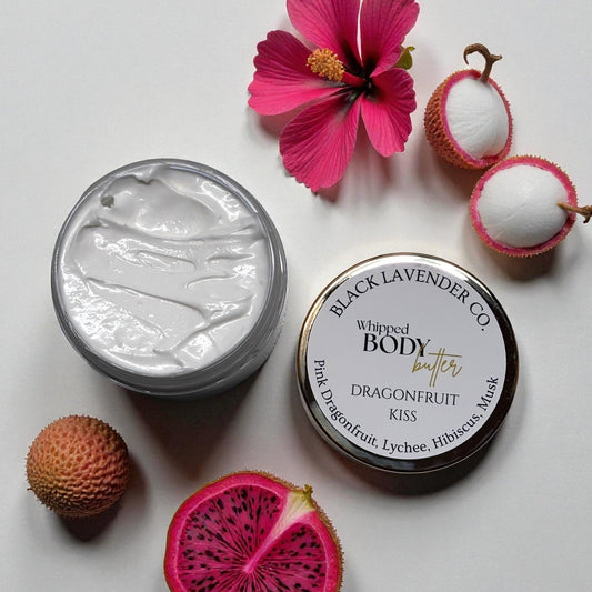 Whipped body butter jar with dragonfruit, lychee, and hibiscus on a light background