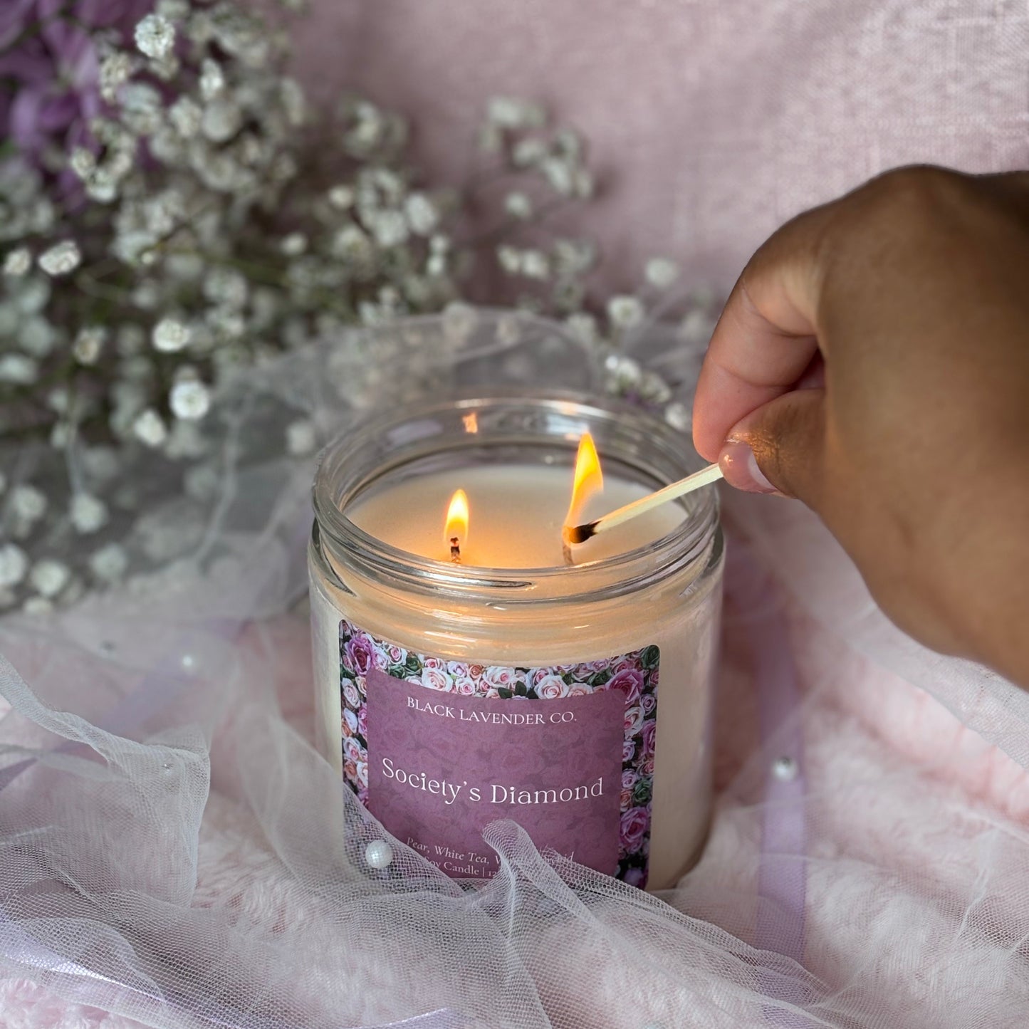 Candle being lit with a decorative background